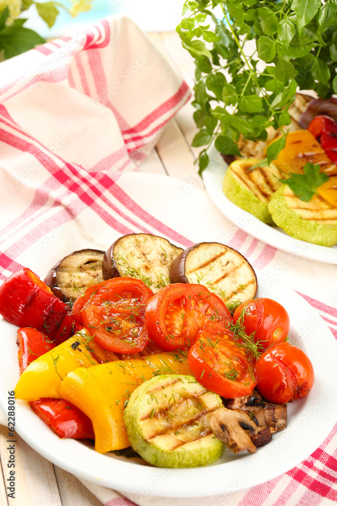 Delicious grilled vegetables on plate on table close-up Delicious grilled vegetables on plate on table close-up