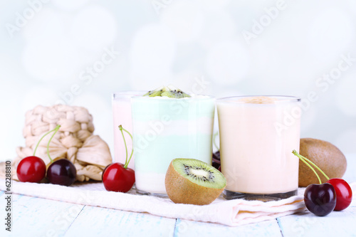 Delicious yogurt with fruits tastes in glasses and fresh fruits