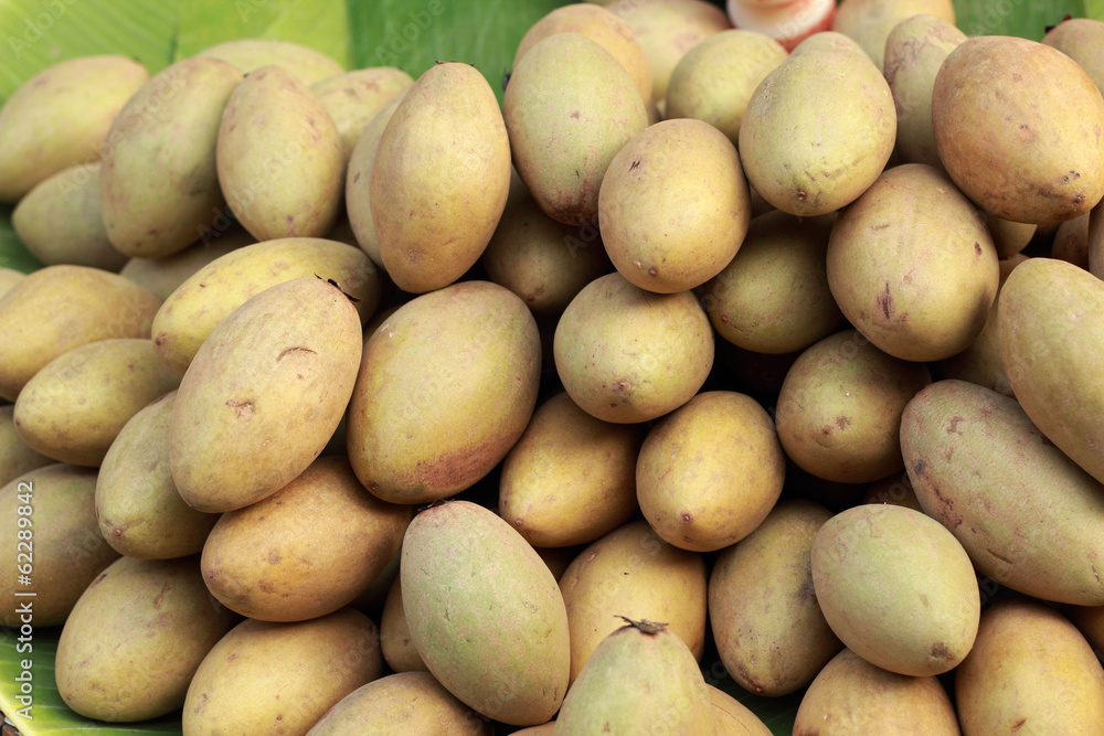 Sapodilla fruit pile in the background. Sapodilla fruit pile in the background.