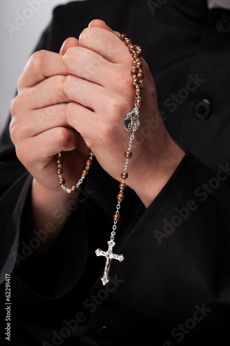 Priest is holding rosary