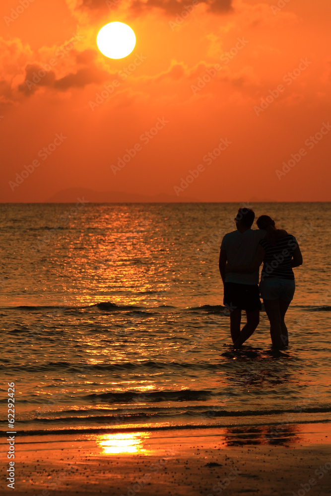 Lover on beach sunset with golden light effect
