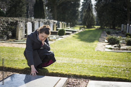 widow at grave of deceased husband