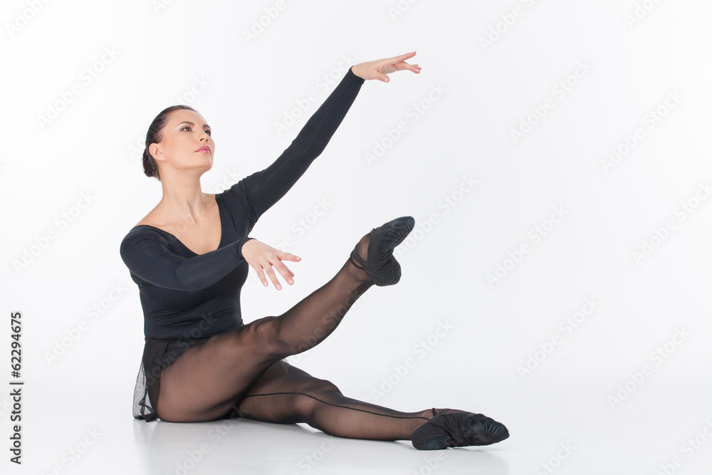 ballet dancer sitting on floor and stretching. ballet dancer sitting on floor and stretching.