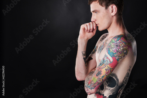 handsome young man covered with tattoo.