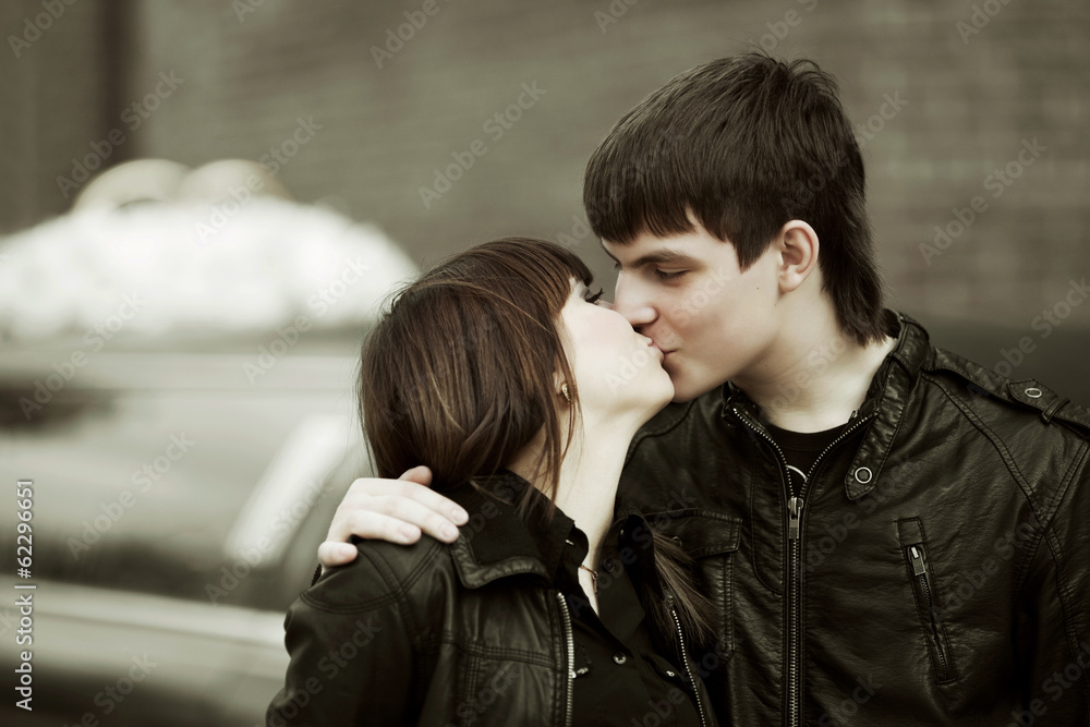 Happy young couple kissing outdoor