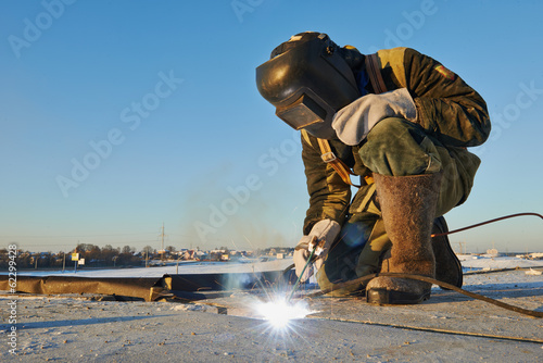welder at construction site photo