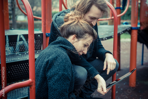 young modern stylish couple using tablet photo