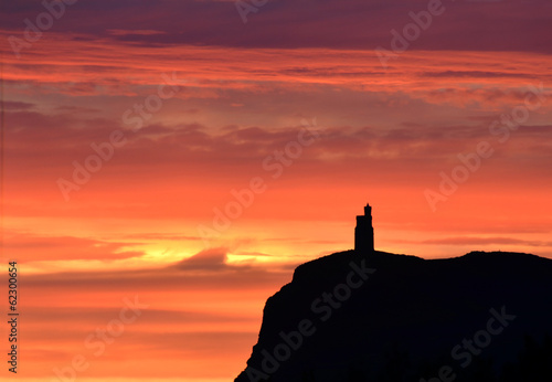 Sunset sky with Milner Tower on Brada Head, Isle of Man, UK