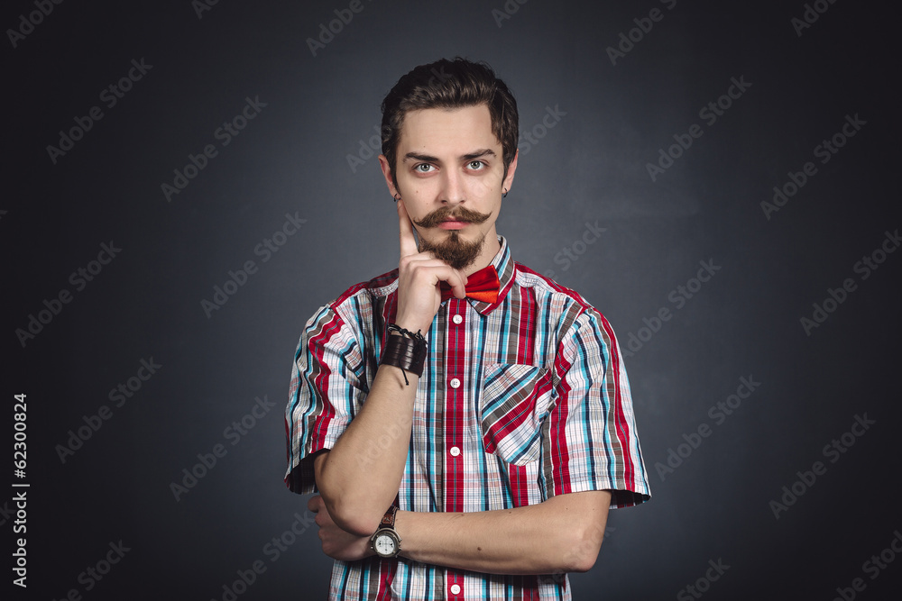 Man in plaid shirt and bow tie in the studio Man in plaid shirt and bow tie in the studio