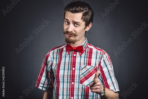 Man in plaid shirt and bow tie in the studio