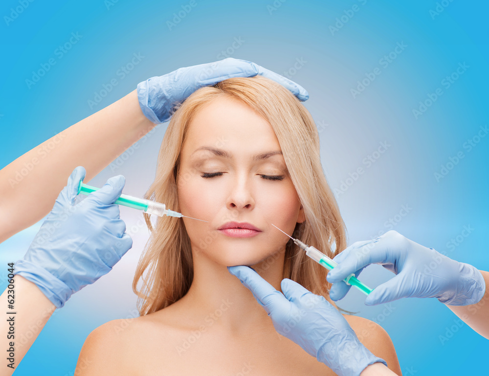 woman face and beautician hands with syringes woman face and beautician hands with syringes