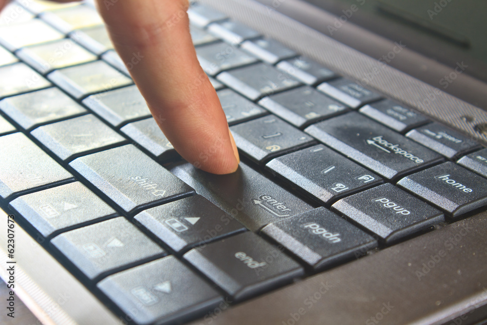finger pushing the button of keyboard finger pushing the button of keyboard