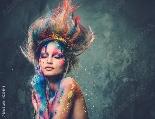 Young woman muse with creative body art and hairdo