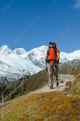 Hiker walks on train in Himalayas