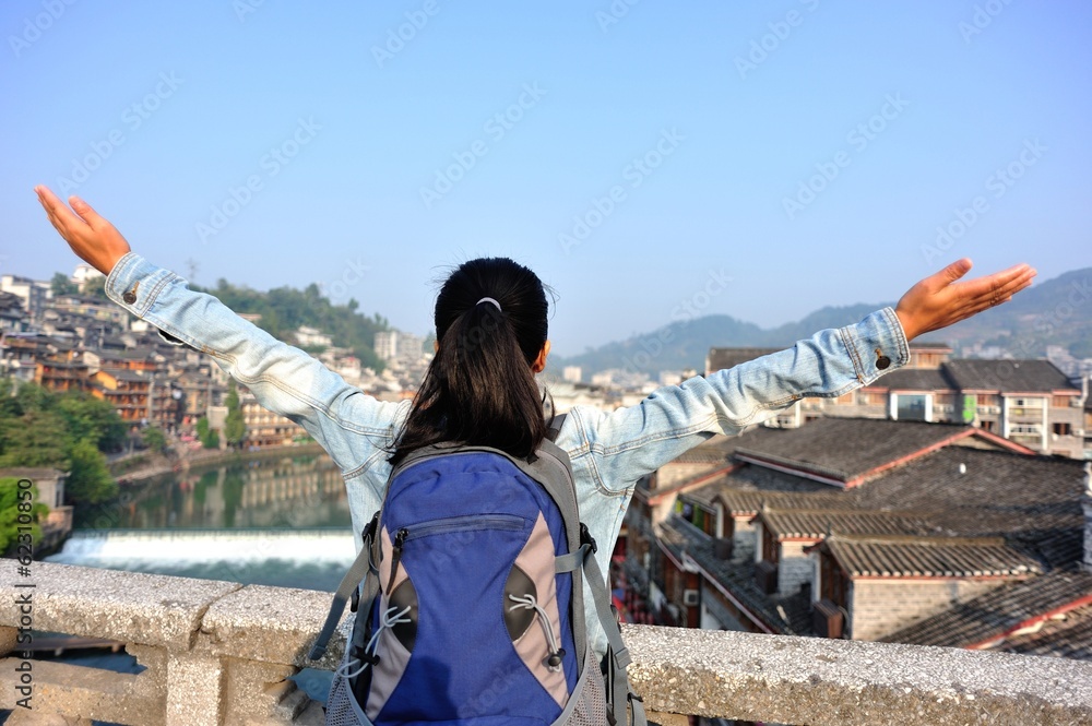 cheering woman tourist open arms at fenghuang ancient town cheering woman tourist open arms at fenghuang ancient town