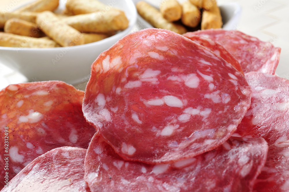 slices of salchichon, spanish cured sausage slices of salchichon, spanish cured sausage