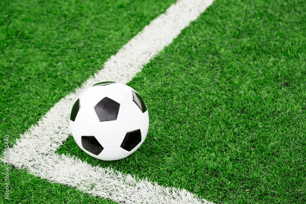Traditional soccer ball on soccer field Traditional soccer ball on soccer field
