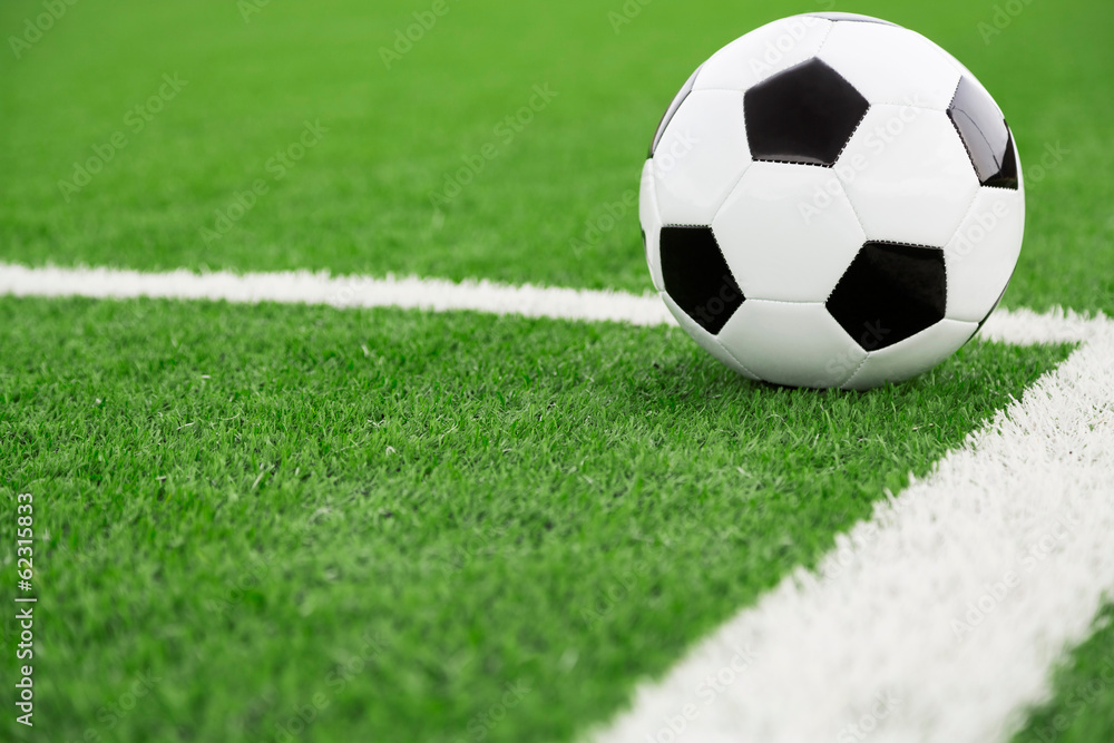 Traditional soccer ball on soccer field Traditional soccer ball on soccer field