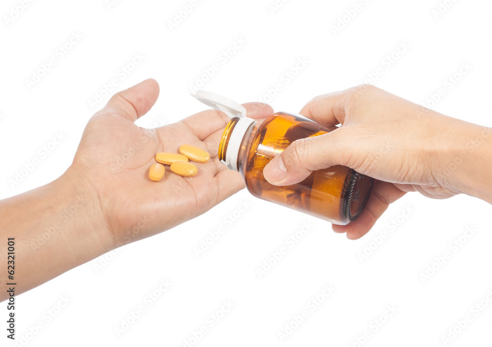 hands with pills and pill container hands with pills and pill container