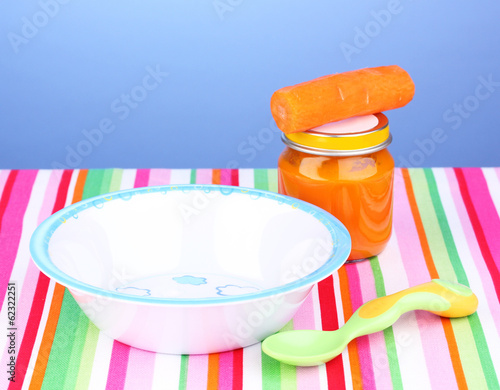 Jar of baby puree with plate and spoon