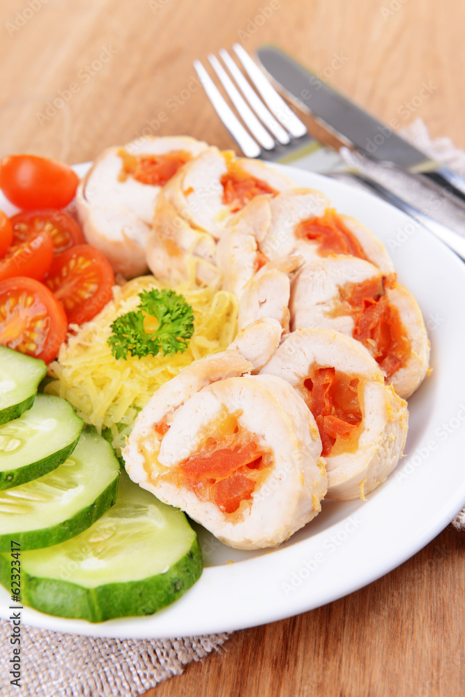 Delicious chicken roll on plate on table close-up Delicious chicken roll on plate on table close-up