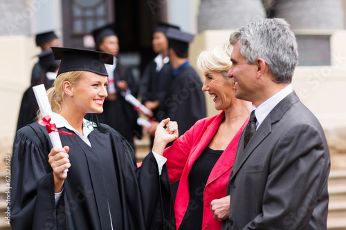 female graduate with parents photo