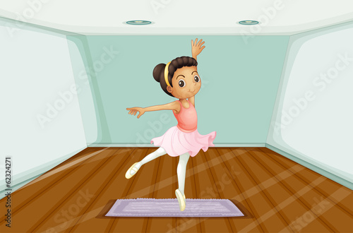 A young ballet dancer dancing above the rug