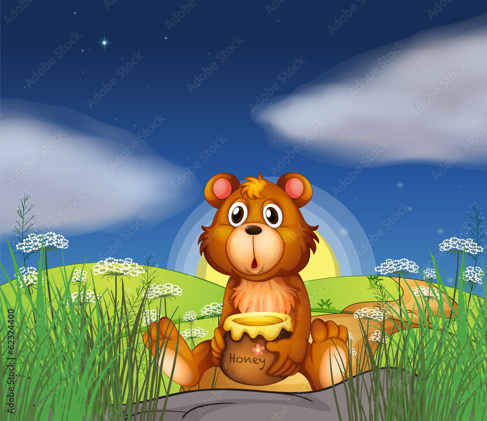 Fototapeta premium A bear at the hilltop holding a pot of honey