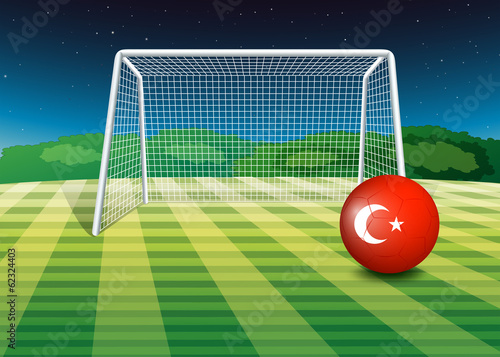 A ball at the soccer field with the flag of Turkey