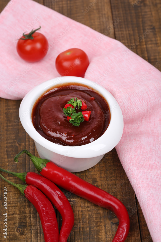 Tomato sauce in bowl on wooden table close-up Tomato sauce in bowl on wooden table close-up