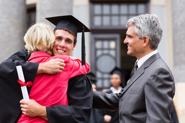 male graduate hugging his mother at graduation