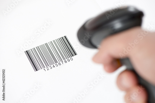 The manual scanner of bar codes in man hand