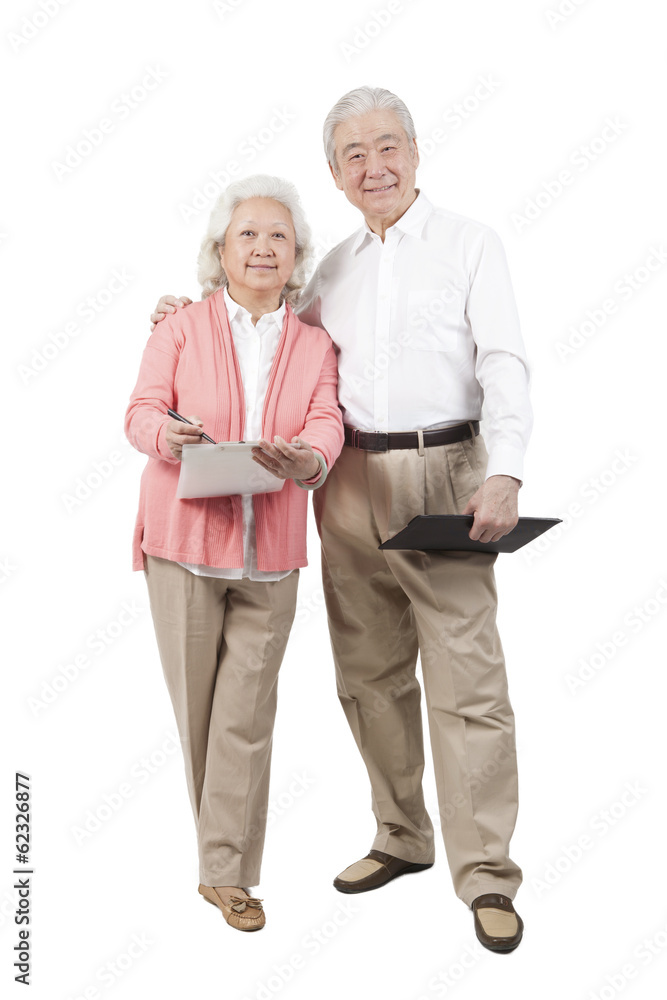 .Senior couple holding questionnaire. .Senior couple holding questionnaire.