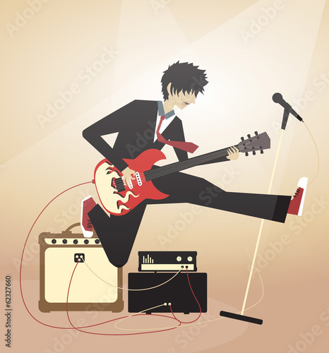 Boy playing on electric guitar and jumping