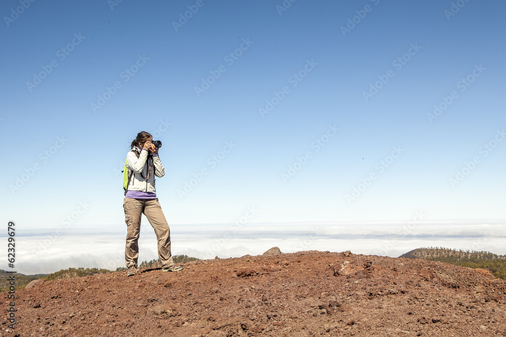 Woman nature Photographer taking pictures outdoors during hiking Woman nature Photographer taking pictures outdoors during hiking