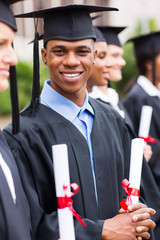 african american male graduates standing with classmates