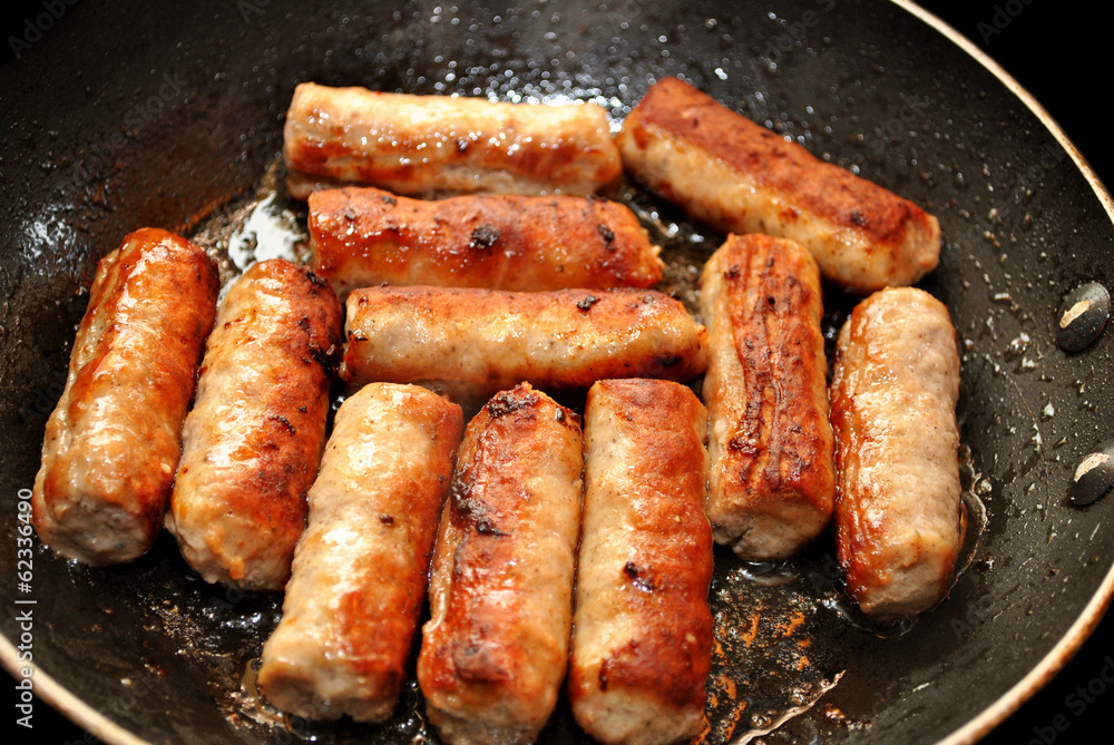 Close-Up of Sausage Links Frying in a Pan Close-Up of Sausage Links Frying in a Pan