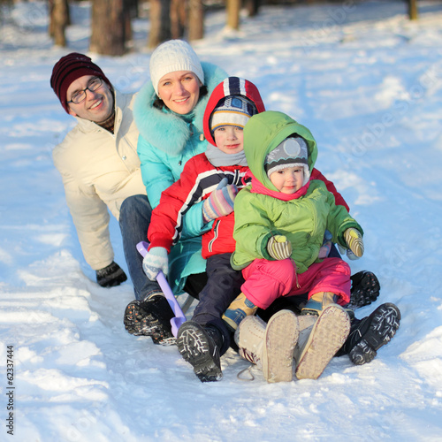 young family sledding