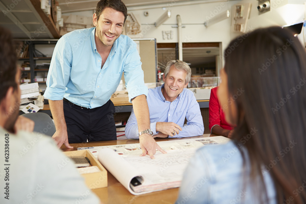 Fototapeta premium Male Boss Leading Meeting Of Architects Sitting At Table