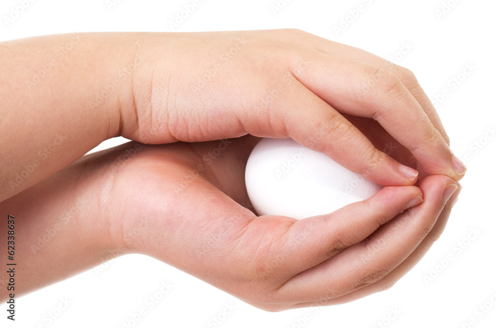 Asian boy holding an egg carefully with both hands Asian boy holding an egg carefully with both hands