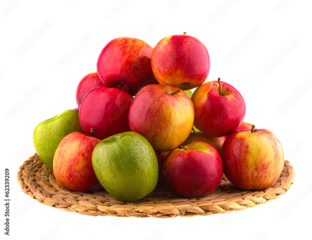 Red and green apples in a wooden basket, isolated Red and green apples in a wooden basket, isolated