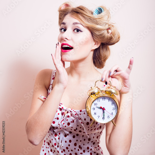 Beautiful happy smiling young pinup woman and clock