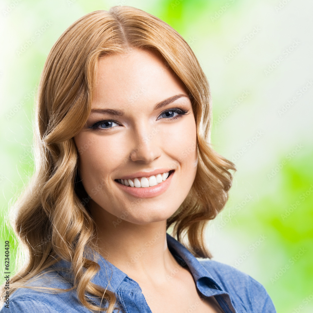Fototapeta premium Happy smiling woman with long hair, outdoor