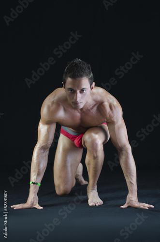 Handsome young muscular man ready to sprint and run © theartofphoto