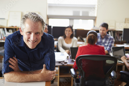 Portrait Of Male Architect With Meeting In Background