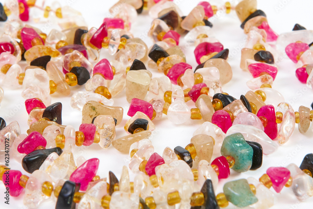 beads of different stones on a white background