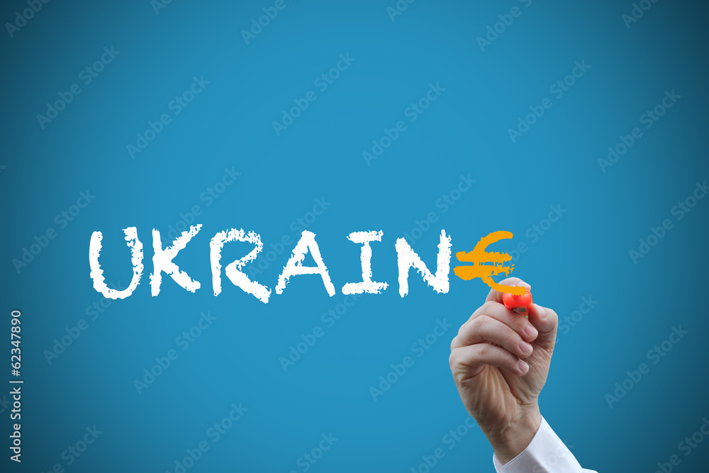 Fototapeta premium hand with pen spelling word Ukraine