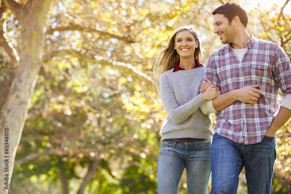 Romantic Couple Walking Through Autumn Woodland Romantic Couple Walking Through Autumn Woodland
