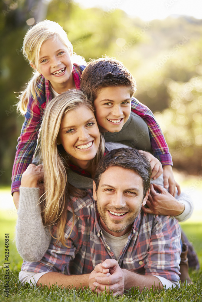 Portrait Of Family Lying On Grass In Countryside Portrait Of Family Lying On Grass In Countryside