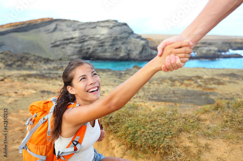 Fotografija Helping hand - hiker woman getting help on hike